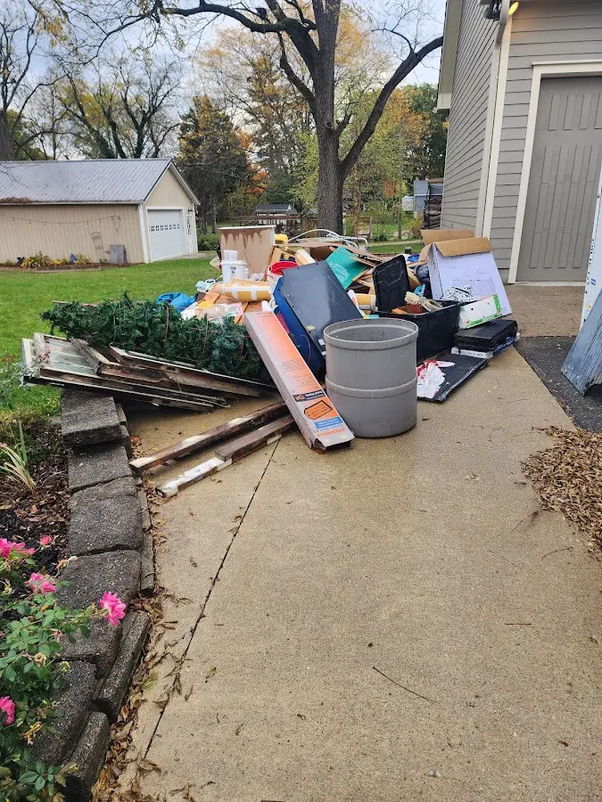 Dumpster being loaded with debris for Estate Cleanout Dumpster Rental in Wilkshire Hills